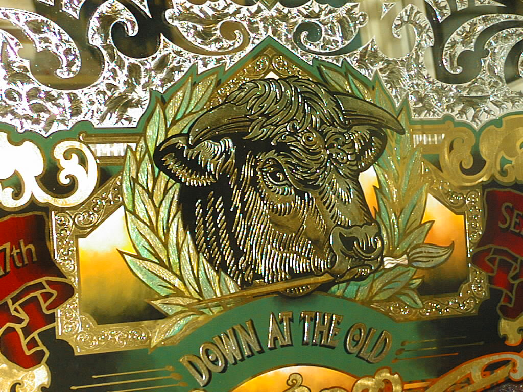 Close up of a bull face on a detailed sign made with glue chipping, back painting and Angel Gilding