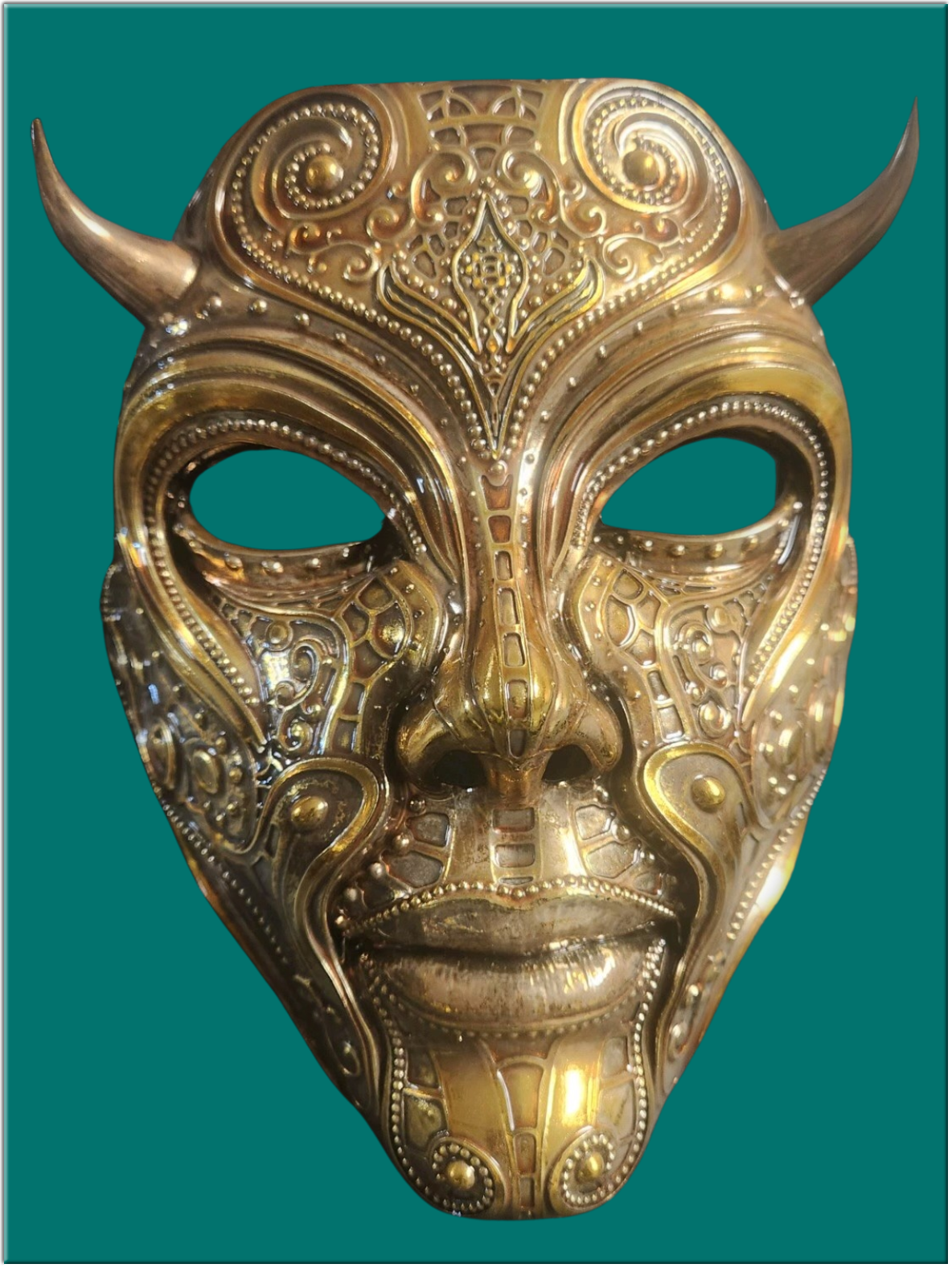 photo of a spray chromed gold mask with horns and ornate detail created by Robert Hulvey
